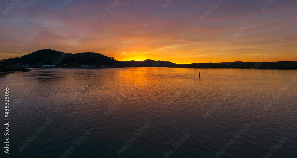 High cloud covered winter sunrise panorama waterscape
