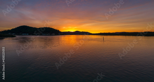 High cloud covered winter sunrise panorama waterscape © Merrillie