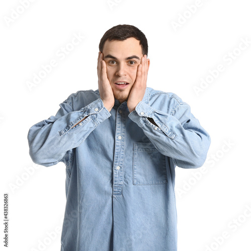 Shocked handsome man on whi...