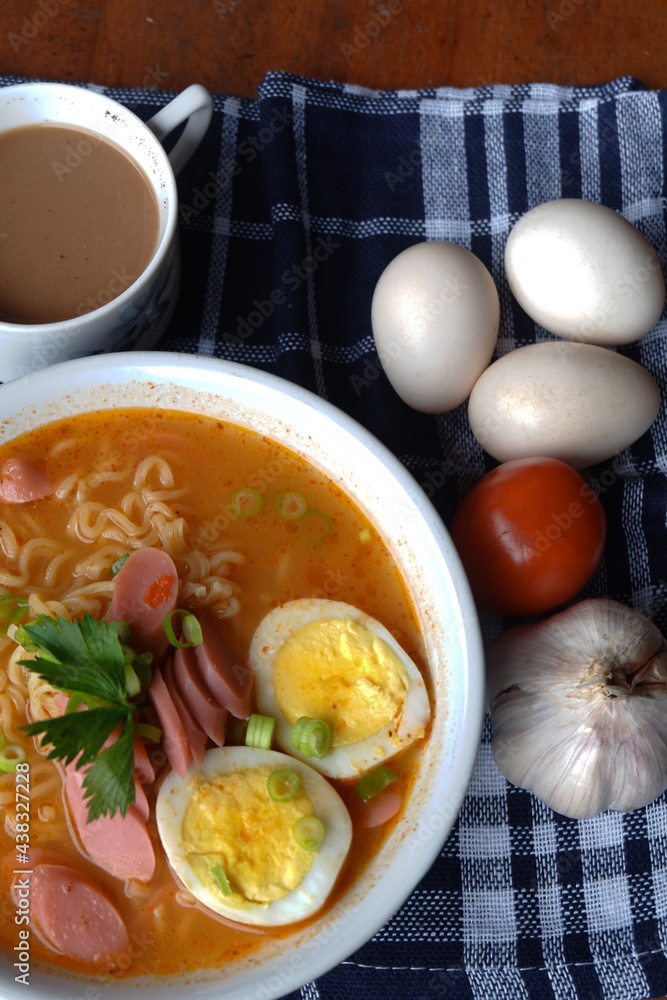 Photo of noodle soup with toppings such as sausages, eggs, and vegetables Photo of noodle soup with toppings such as sausages, eggs, and vegetables