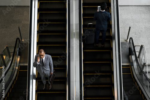 Businessmen on the escalator