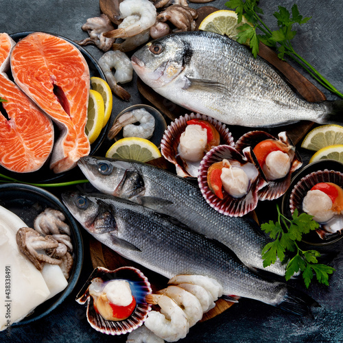Seafood variety on dark background. Healthy diet eating concept.