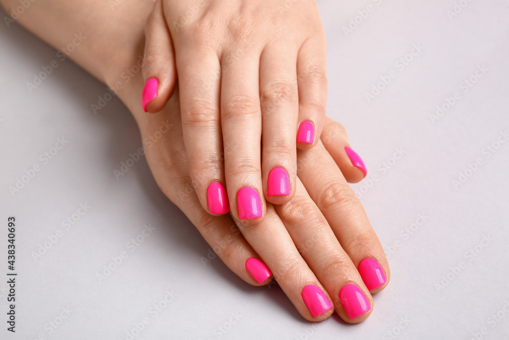 Woman with beautiful manicure on light background