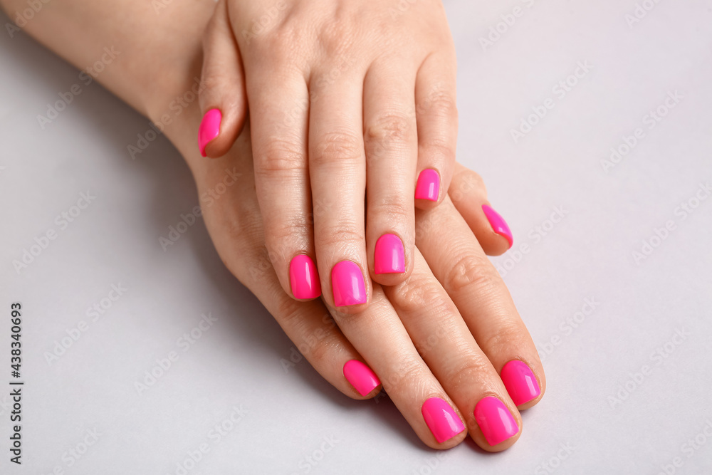 Woman with beautiful manicure on light background Woman with beautiful manicure on light background