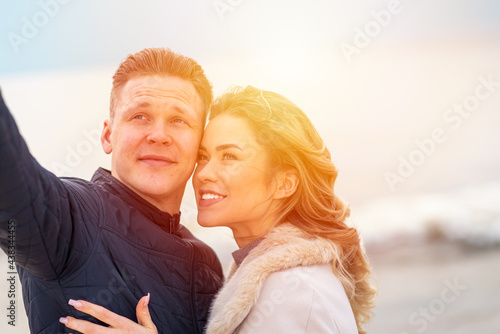 Happy romantic Smiling couple taking selfie on the sunny beach