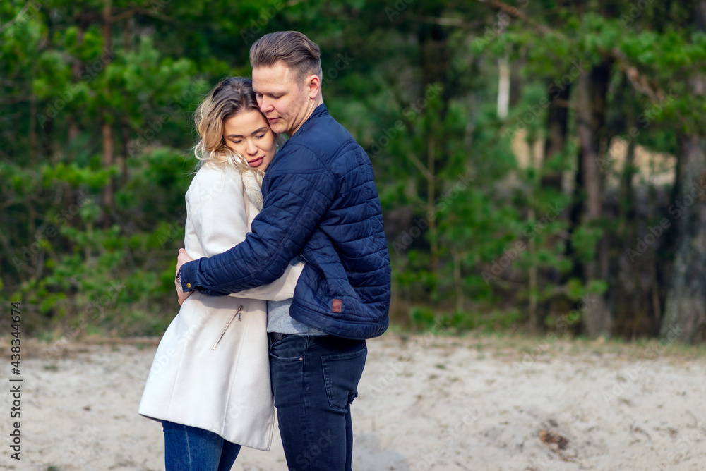 Happy loving couple enjoying of happiness love and tenderness, dating, romance.Couple hugging in love at spring park. Happy loving couple enjoying of happiness love and tenderness, dating, romance.Couple hugging in love at spring park.