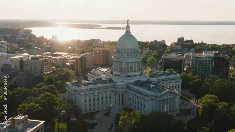 Aerial overhead view of street leading to Madison city center and capitol building. Warm sunset light at background	