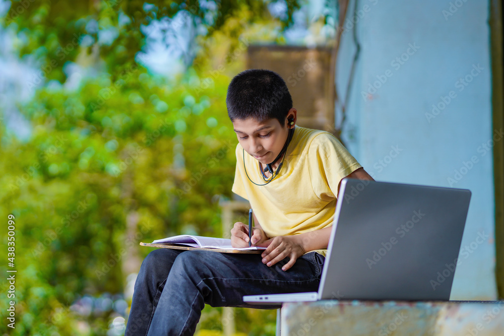 Asian boy using Laptop computer for online study homeschooling during home quarantine. homeschooling, online study, home quarantine, online learning, corona virus or education technology concept