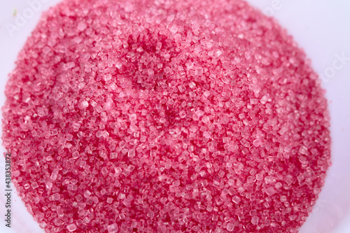 Red sugar for cotton candy in white plate