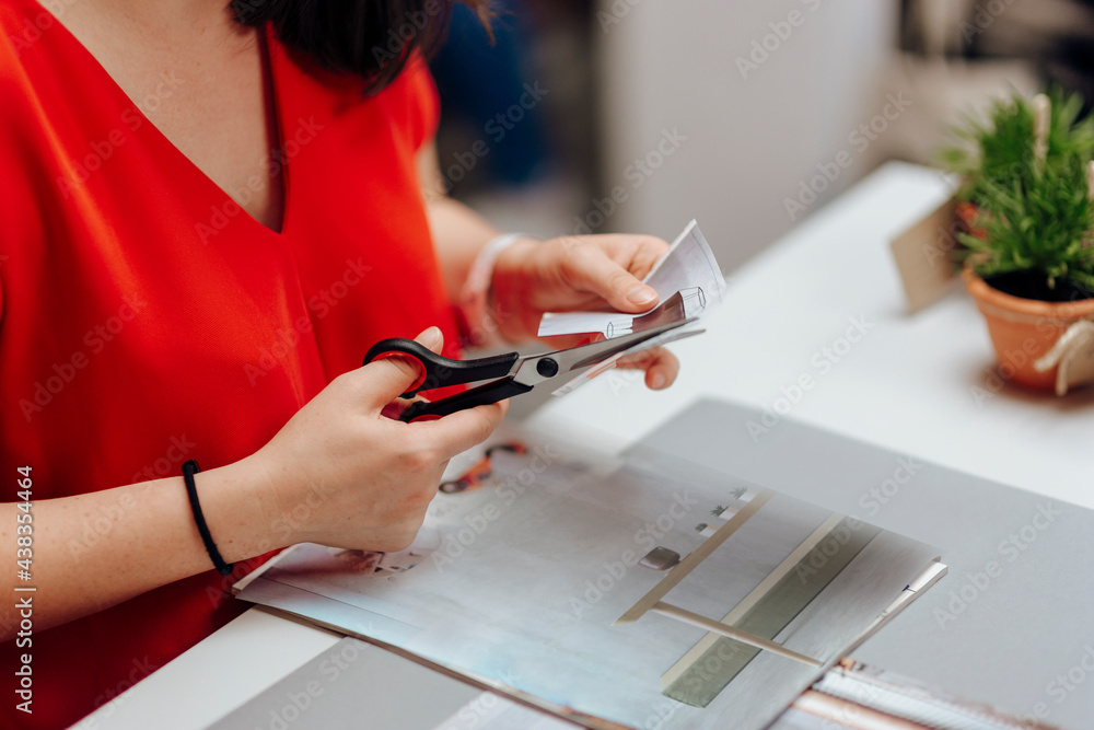 Fototapeta premium Designer cutting a pattern in a paper