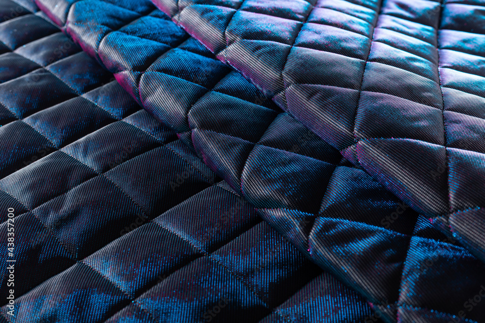 Obraz premium the surface of blue-violet jacket fabric with padding polyester folded