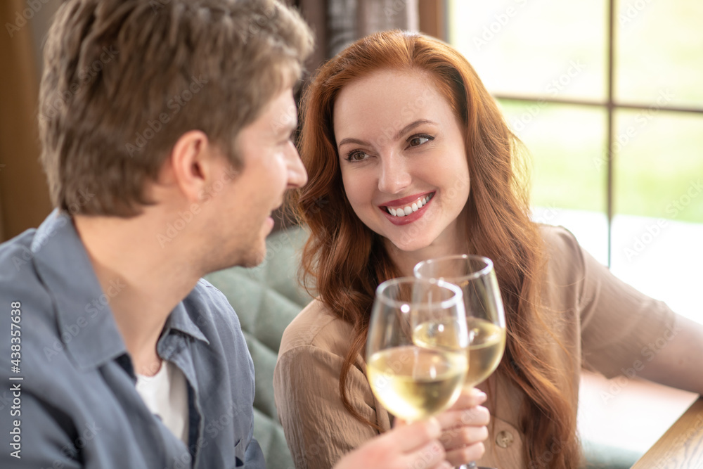 Beautiful woman and attentive man with glasses of wine Beautiful woman and attentive man with glasses of wine