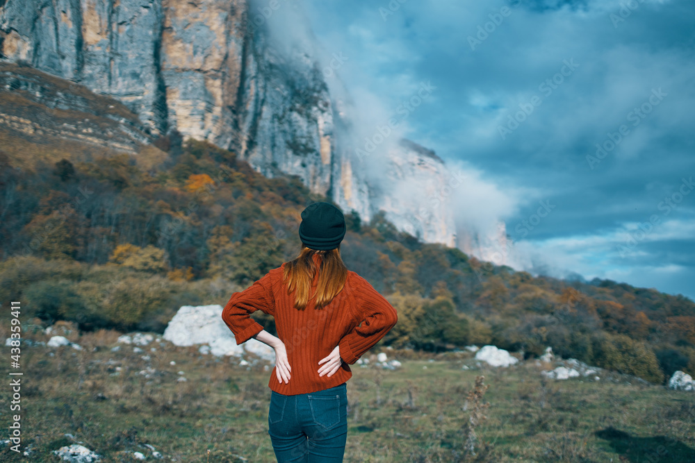 Traveler in a sweater in the autumn mountains outdoors landscape blue sky high rocks model Traveler in a sweater in the autumn mountains outdoors landscape blue sky high rocks model