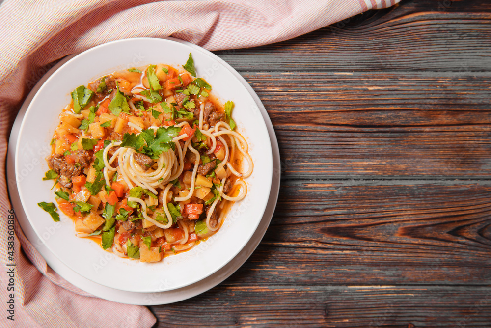 noodle meat, herbs in a plate on a towel on a dark wooden , Asian cuisine noodle meat, herbs in a plate on a towel on a dark wooden , Asian cuisine