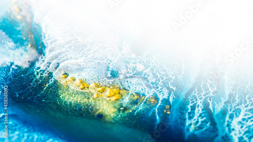 Tidewater alcohol stains of paint with the addition of gold powder. Subtle waves of paint, abstract blue waves of the ocean, lines of marble. Liquid paints, gradient stains, painting. Tinting Tidewate photo