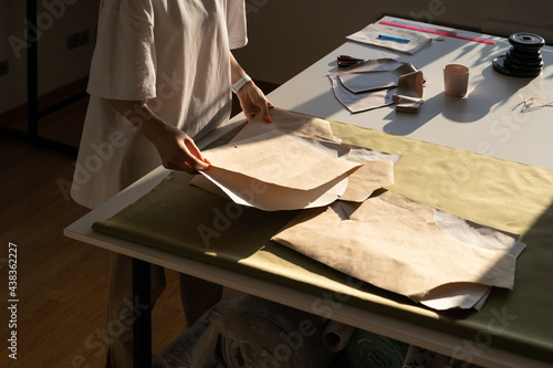 Konstfotografi Fashion designer hold new sewing patterns on craft paper, unrecognizable closeup