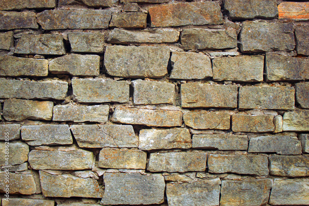Naklejka premium Aged stone wall texture background. antique rock masonry