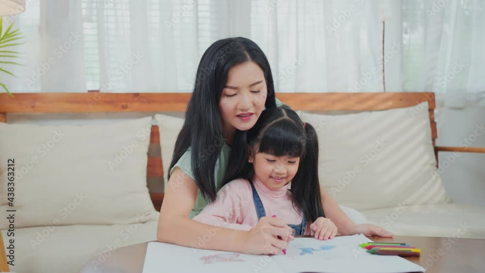 Asian little girl painting picture with mother in the living room. Asian little girl painting picture with mother in the living room.