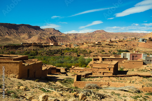 a scattering of mudbrick villages in the High Atlas mountains with a clear blue sky © Ian