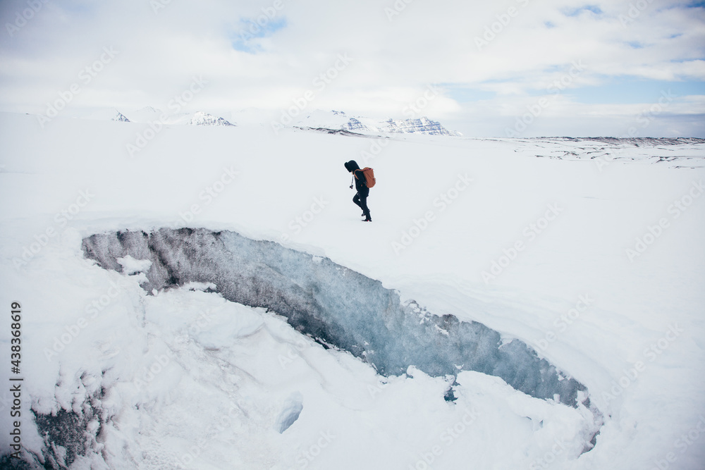 Person hiking on frozen remote terrain