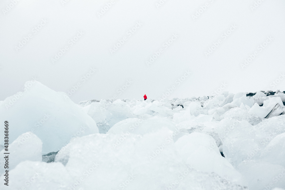 Anonymous tourist exploring frozen terrain in clouds Anonymous tourist exploring frozen terrain in clouds