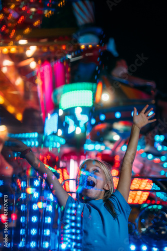 Little girl having exciting experience in the roller coaster