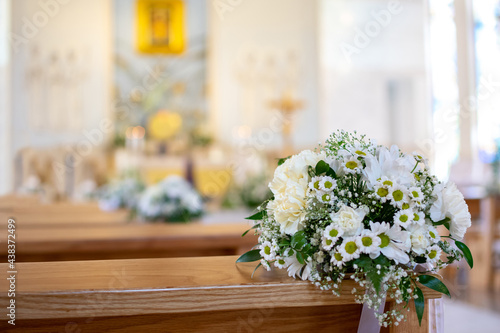 Beautiful church decorated of white flowers in church for wedding or first communion ceremony