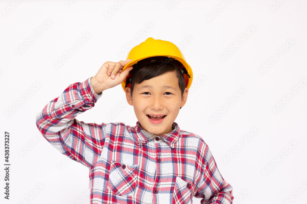 Close-up of an Asian boy wearing a hardhat smiling and looking at camera, standing isolated on white background. Close-up of an Asian boy wearing a hardhat smiling and looking at camera, standing isolated on white background.