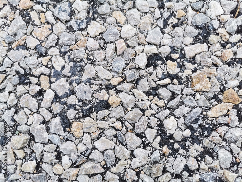 Asphalt road. Pebble stone on asphalt. Asphalt road. Pebble stone on asphalt.