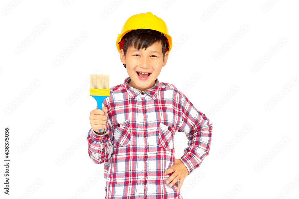 Little kid as a construction worker wearing yellow helmet with a paintbrush in his hand..White background studio picture. Little kid as a construction worker wearing yellow helmet with a paintbrush in his hand..White background studio picture.