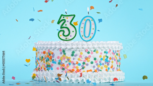 Foto Colorful tasty birthday cake with candles shaped like the number 30