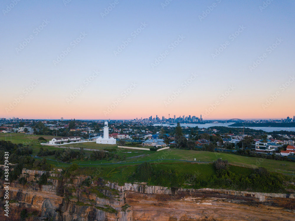 Macquarie Lighthouse and Sydney CBD skyline in the morning with clear sky.