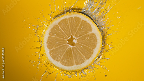 Fresh lemon slice falling i...