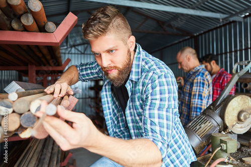 Craftsman during a quality control in the material warehouse photo