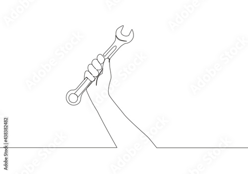 One single line drawing of man holding stainless steel wrench key. Mechanic and handyman tools concept. Continuous line draw vector design illustration