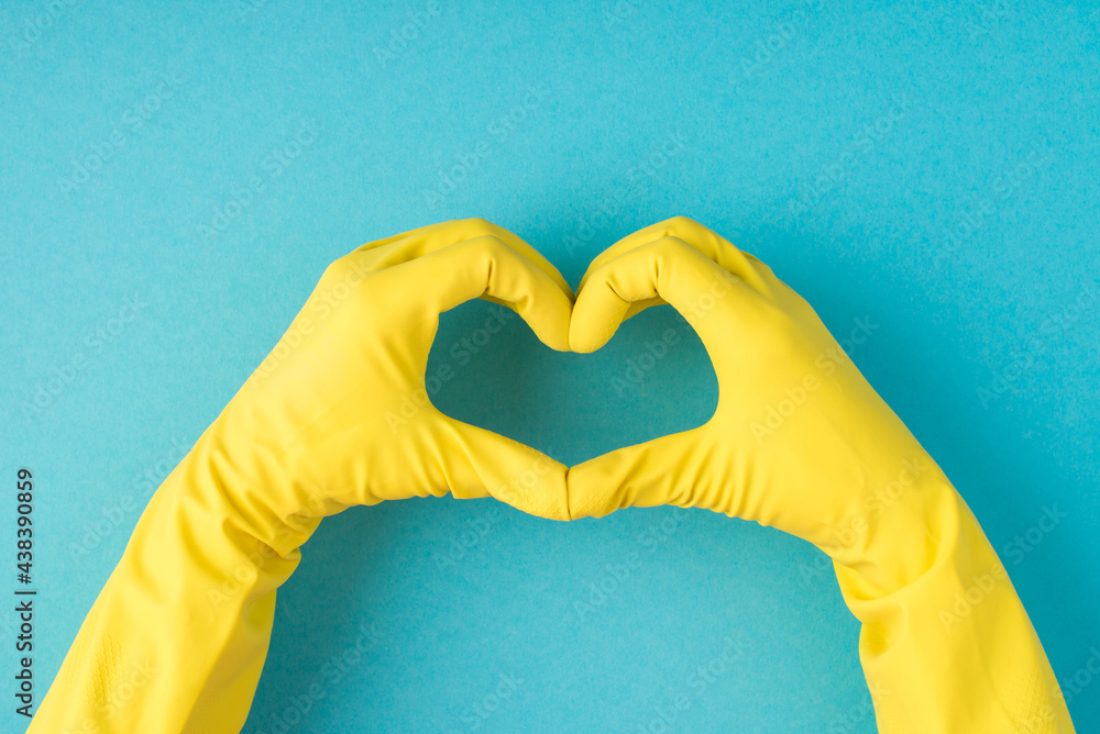 Top view photo of hands in yellow rubber gloves making heart with ...