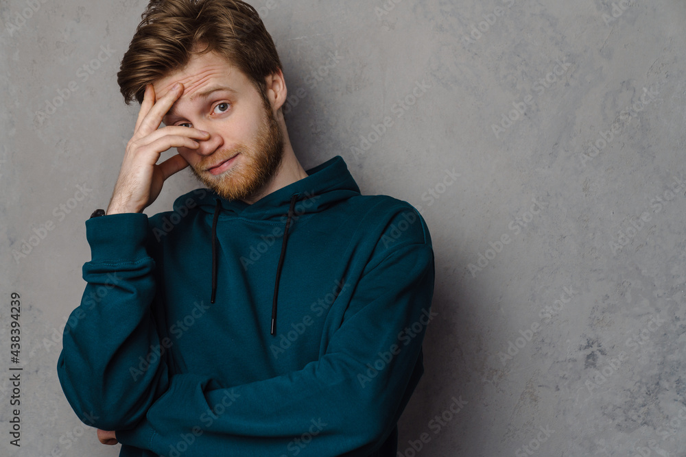 White ginger man with beard posing and covering his face White ginger man with beard posing and covering his face