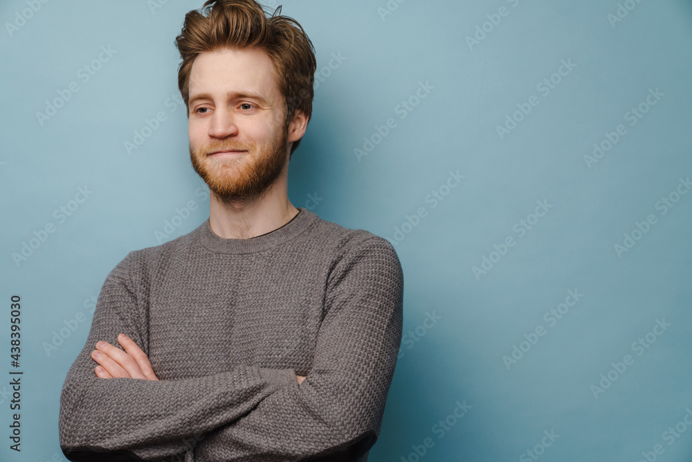 White ginger man smiling while posing with arms crossed White ginger man smiling while posing with arms crossed