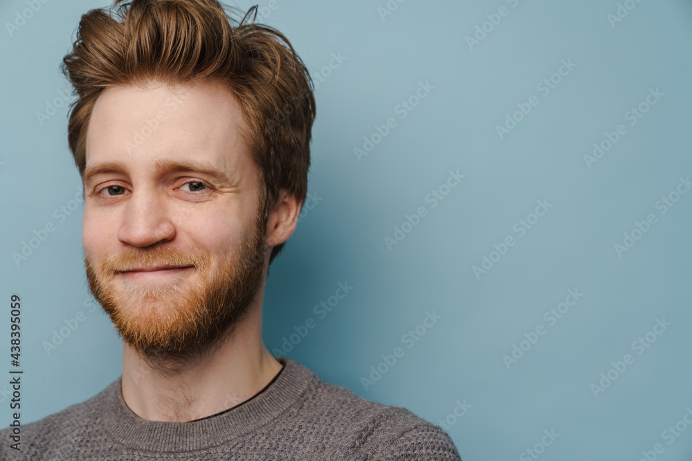 Fototapeta premium White ginger man with beard smiling and looking at camera