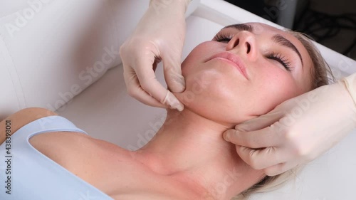 Wallpaper Mural Chin massage of woman young woman during face massage at beauty salon Torontodigital.ca