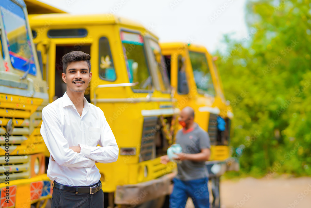 Young indian businessman with his freight forward lorry or truck. Young indian businessman with his freight forward lorry or truck.