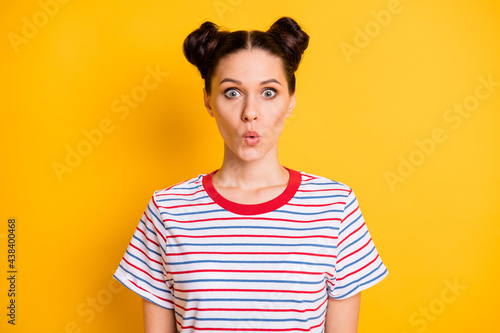 Photo of funny shocked young woman wear striped t-shirt big eyes lips pouted isolated yellow color background