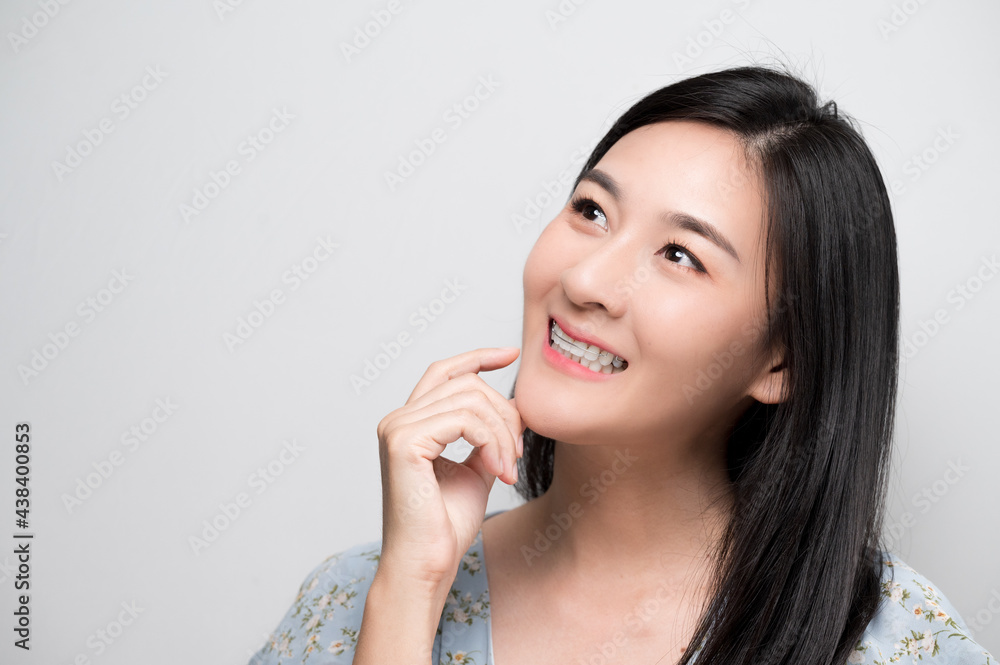 Asian woman holding orthodontic retainers.Teeth retaining tools after braces ... Asian woman holding orthodontic retainers.Teeth retaining tools after braces ...