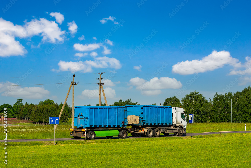 Truck on the road with blue containers