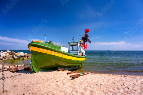 Fototapeta Naklejka Na Ścianę i Meble -  Summer scenery of the Baltic Sea with fishing boat in Gdynia Orlowo, Poland