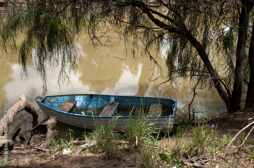 Hillston Australia, small boat moored under a tree on riverbank photo