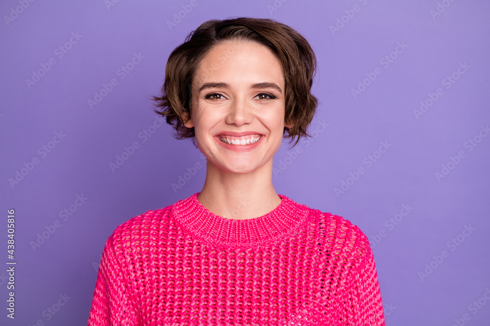 Portrait of optimistic cute girl wear pink sweater isolated on violet color background Portrait of optimistic cute girl wear pink sweater isolated on violet color background