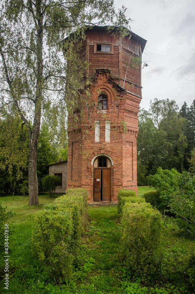 Naklejka premium Old red brick and wood water tower, Spare, Latvia.
