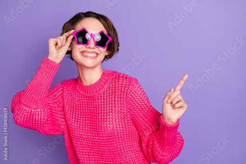 Photo of young cheerful girl happy positive smile enjoy party wear sunglass dance isolated over purple color background