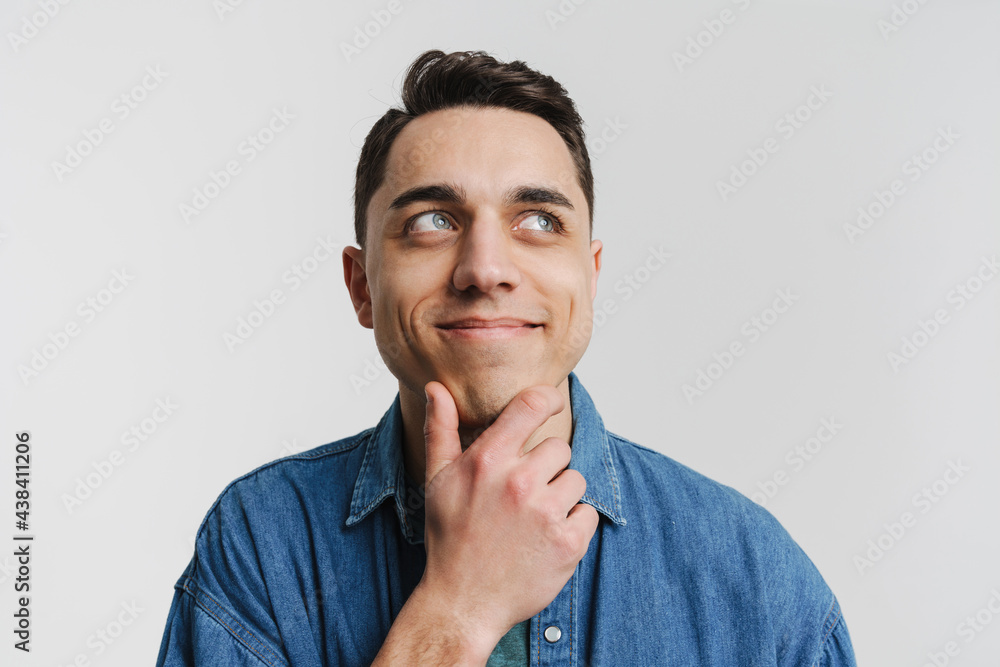 Young brunette white man smiling and looking aside Young brunette white man smiling and looking aside